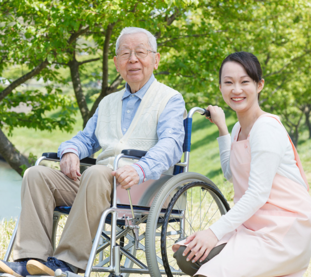 elderly man and caregiver smiling